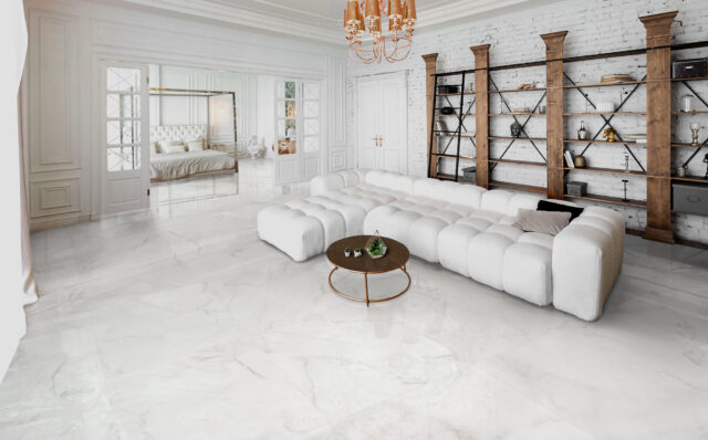 Cozy living room with white shiny floor tiles and white sofa set from our tile store