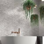 Bathroom-with-bathtub-and-plants-hanging-from-the-ceiling-wall-tiles