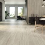 Livingroom-with-woodlike-floor-tiles-sitting-areas-and-sofa-in-the-background