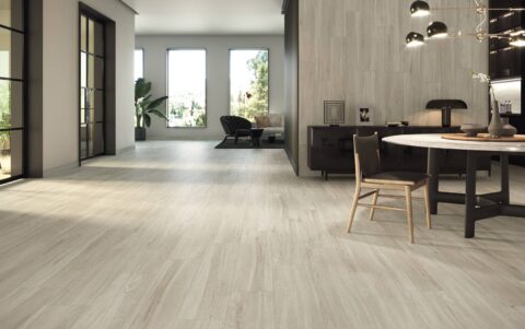 Livingroom-with-woodlike-floor-tiles-sitting-areas-and-sofa-in-the-background