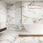 Bathroom-with-bathtub-with-faucet-in-gold-tiles-on-floor-and-walls-with-details-in-gold
