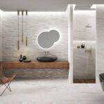 Bathroom-with-black-bathtub-and-sinks-backlighted-mirror