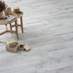 Woodlike-tiles-floor-with-stools-with-a-plant-and-cubes