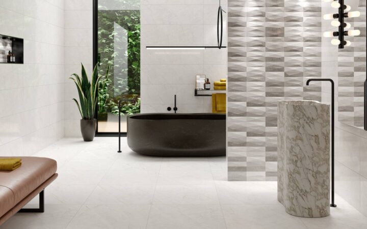 Bathroom-with-tall-sink-of-marble-effect-tiles-black-bathtub-and-plant
