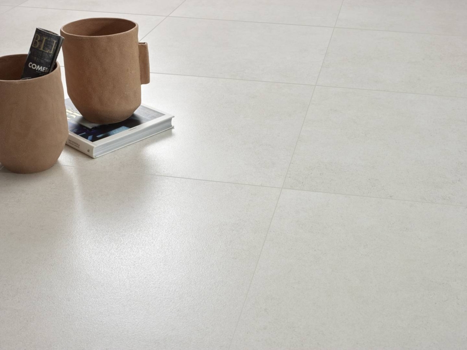 Creme colored floor tiles with a decor on a book