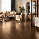 Livingroom with brown woodlike floor tiles and creme color set of sofa