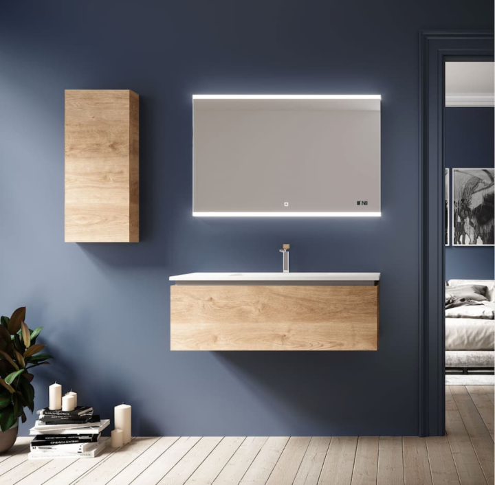 Modern bathroom with blue walls, wooden vanity, backlit mirror, and adjacent bedroom view.