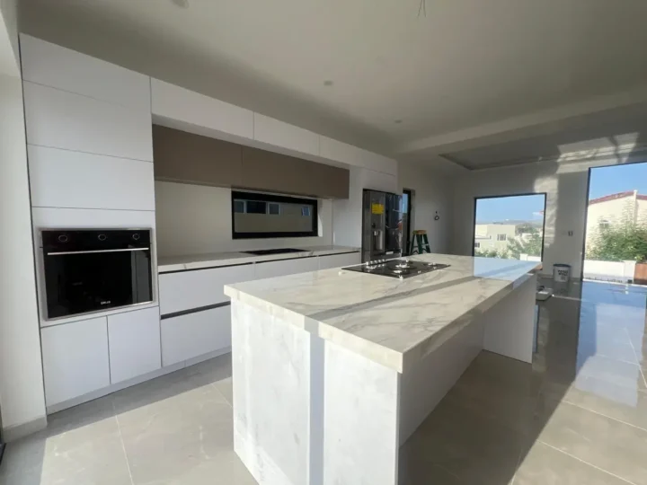 A-gray-and-white-marbled-kitchen-countertop-and-white-cabinets