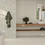 Warm creme colored wall tiles in bathroom with a tub and sink