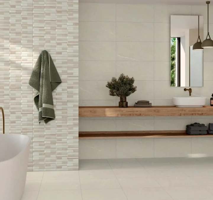 Warm creme colored wall tiles in bathroom with a tub and sink